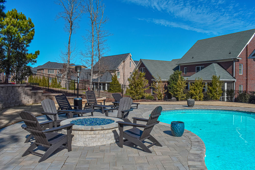 Poolside firepit setting hardscaped 